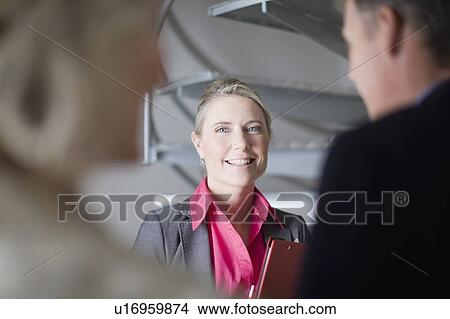 Picture - Businesswoman smiling in office. Fotosearch