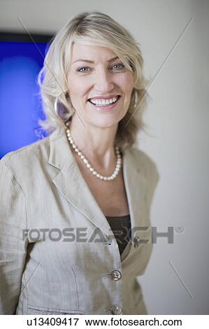 Stock Photo - Businesswoman smiling in office. Fotosearch