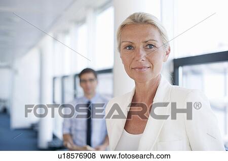 Stock Photo - Businesswoman smiling in office. Fotosearch
