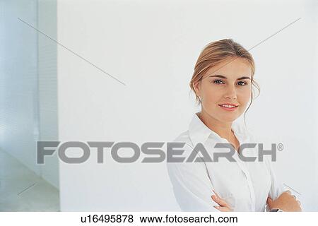 Businesswoman smiling with arms folded View Large Photo Image Stock Photo - Businesswoman smiling with arms folded. Fotosearch