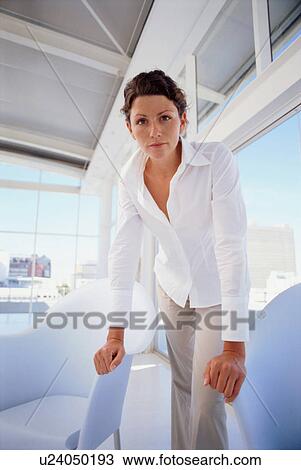 Businesswoman standing in office View Large Photo Image Stock Image - Businesswoman standing in office. Fotosearch