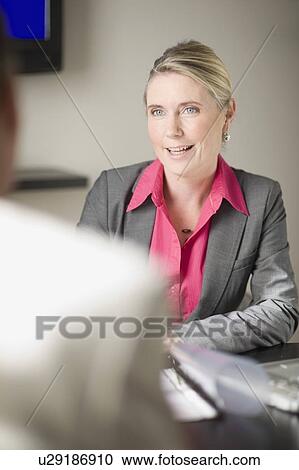 Businesswoman talking in office View Large Photo Image Stock Image - Businesswoman talking in office. Fotosearch