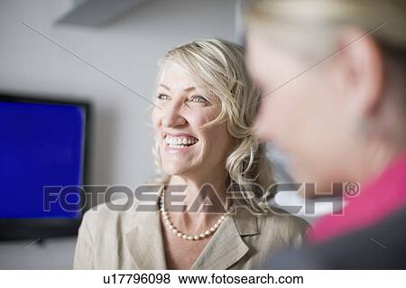 Businesswoman talking in office View Large Photo Image Stock Photo - Businesswoman talking in office. Fotosearch