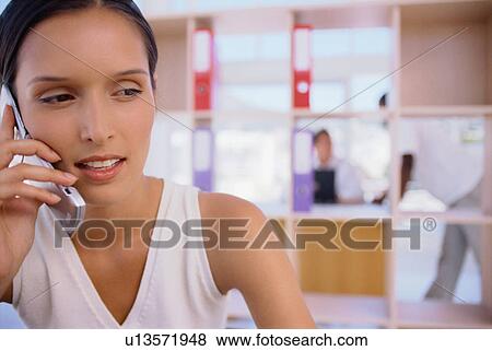 Stock Photo - Businesswoman talking on cell phone. Fotosearch