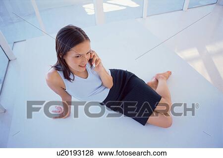 Stock Photo - Businesswoman talking on cell phone. Fotosearch