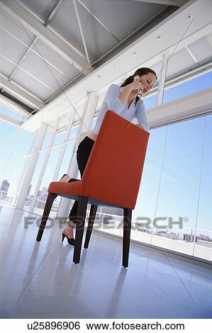 Stock Photograph - Businesswoman talking on cell phone. Fotosearch