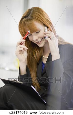 Businesswoman talking on cell phone View Large Photo Image Stock Photograph - Businesswoman talking on cell phone. Fotosearch