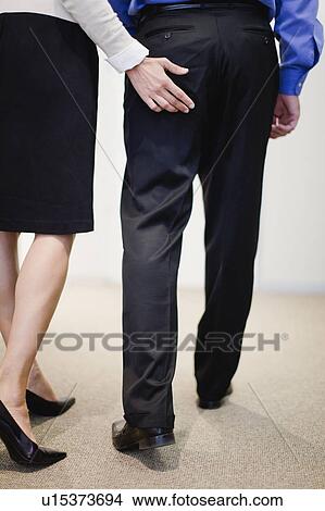 Businesswoman touching peer’s buttocks View Large Photo Image Picture - Businesswoman touching peer’s buttocks. Fotosearch