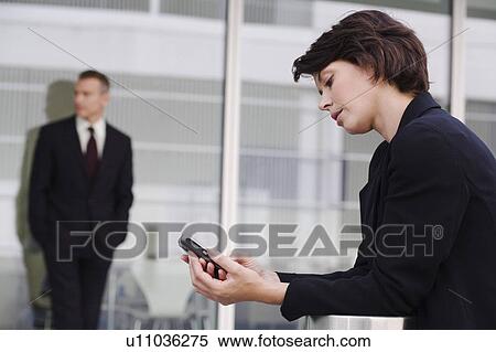Stock Photography - Businesswoman using cell phone. Fotosearch