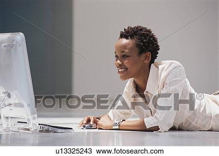 Businesswoman using computer on floor View Large Photo Image Stock Image - Businesswoman using computer on floor. Fotosearch