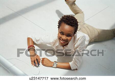 Stock Photo - Businesswoman using computer on floor. Fotosearch