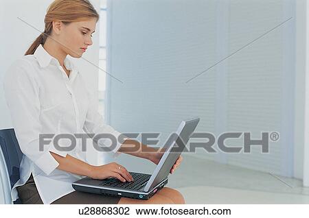 Businesswoman using laptop in office View Large Photo Image Stock Image - Businesswoman using laptop in office. Fotosearch