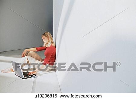 Businesswoman using laptop on floor View Large Photo Image Stock Photography - Businesswoman using laptop on floor. Fotosearch