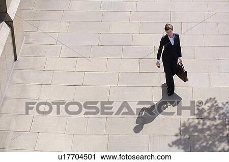 Businesswoman walking in courtyard View Large Photo Image Stock Image - Businesswoman walking in courtyard. Fotosearch
