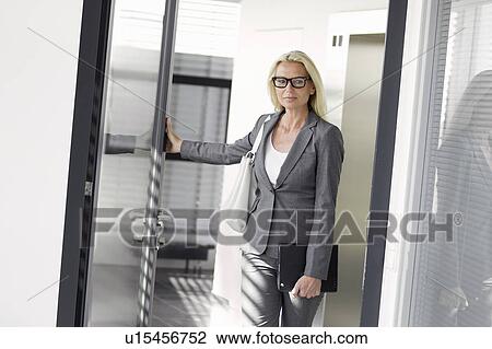 Businesswoman walking in office View Large Photo Image Stock Image - Businesswoman walking in office. Fotosearch