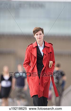 Stock Photography - Businesswoman wearing trench coat. Fotosearch