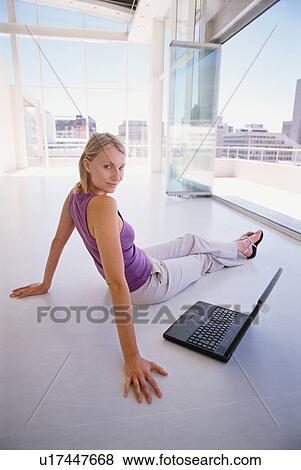 Businesswoman with laptop on floor View Large Photo Image Stock Photo - Businesswoman with laptop on floor. Fotosearch