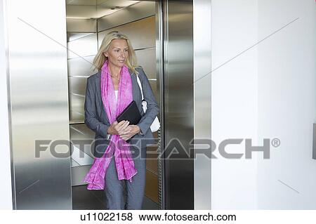 Businesswoman with tablet in elevator View Large Photo Image Stock Photo - Businesswoman with tablet in elevator. Fotosearch