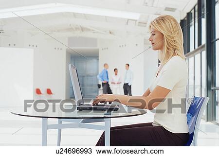 Businesswoman working on laptop View Large Photo Image Stock Image - Businesswoman working on laptop. Fotosearch