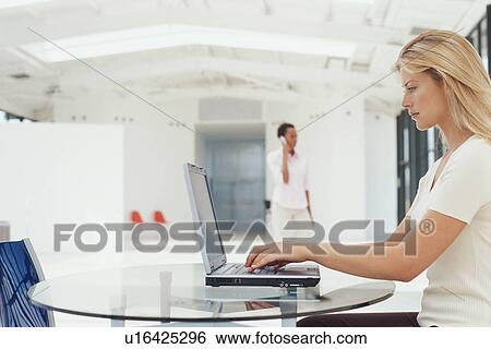 Businesswoman working on laptop View Large Photo Image Stock Photograph - Businesswoman working on laptop. Fotosearch