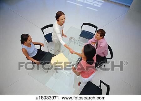 Businesswomen shaking hands in office View Large Photo Image Stock Image - Businesswomen shaking hands in office. Fotosearch