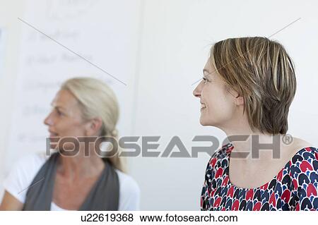 Businesswomen sitting in conference View Large Photo Image Stock Photo - Businesswomen sitting in conference. Fotosearch