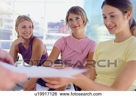 Businesswomen sitting in meeting View Large Photo Image Stock Photograph - Businesswomen sitting in meeting. Fotosearch