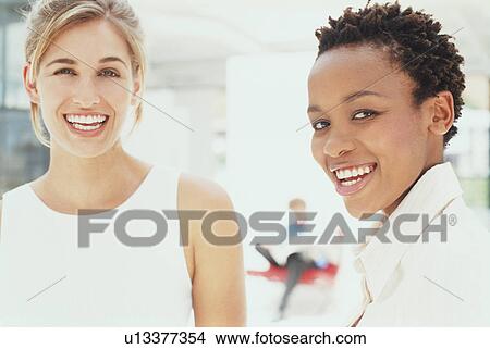Businesswomen smiling together View Large Photo Image Picture - Businesswomen smiling together. Fotosearch