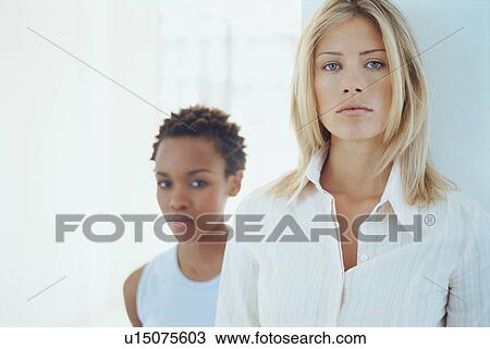 Stock Image - Businesswomen standing together. Fotosearch