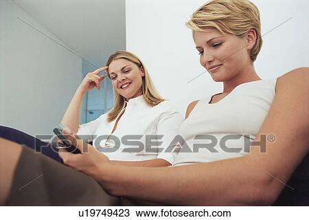 Businesswomen talking on couch View Large Photo Image Stock Image - Businesswomen talking on couch. Fotosearch