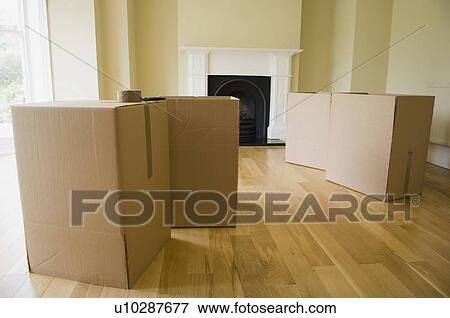 Cardboard boxes in new home View Large Photo Image Stock Photo - Cardboard boxes in new home. Fotosearch