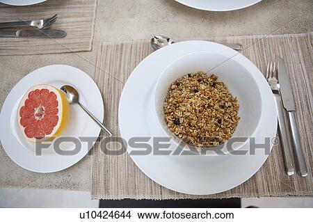 Picture - Cereal and grapefruit breakfast on table. Fotosearch