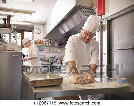 Stock Photography - Chef making bread in restaurant kitchen. Fotosearch