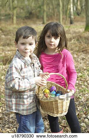 Children carrying basket of Easter eggs View Large Photo Image Stock Image - Children carrying basket of Easter eggs. Fotosearch