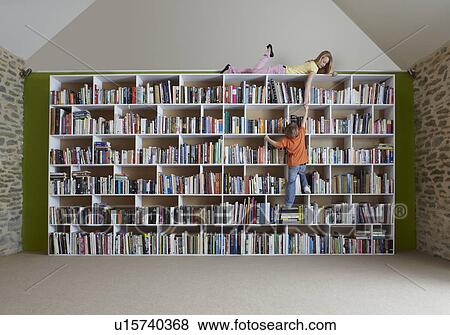 Stock Photo - Children climbing bookshelves. Fotosearch