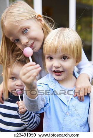 Children eating lollipops View Large Photo Image Stock Image - Children eating lollipops. Fotosearch