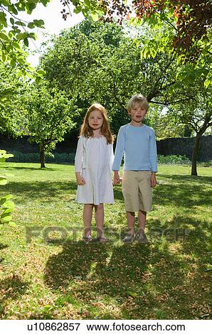 Children holding hands in backyard View Large Photo Image Stock Photo - Children holding hands in backyard. Fotosearch