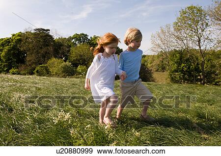 Stock Photo - Children holding hands in field. Fotosearch