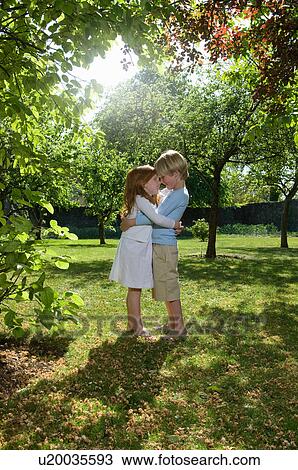 Children hugging in backyard View Large Photo Image Stock Image - Children hugging in backyard. Fotosearch