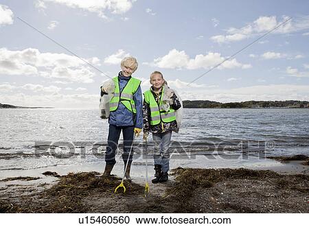 Children in safety vests cleaning beach View Large Photo Image Stock Image - Children in safety vests cleaning beach. Fotosearch
