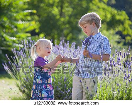 Children picking flowers together View Large Photo Image Stock Image - Children picking flowers together. Fotosearch