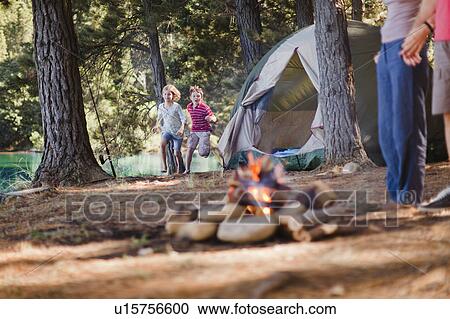 Stock Image - Children playing in campsite. Fotosearch