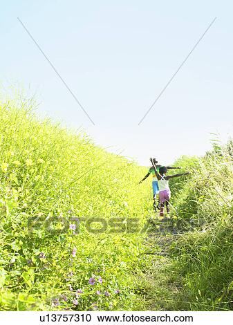 Children playing in field of flowers View Large Photo Image Stock Image - Children playing in field of flowers. Fotosearch