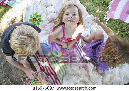 Children playing on blanket in backyard View Large Photo Image Stock Photo - Children playing on blanket in backyard. Fotosearch