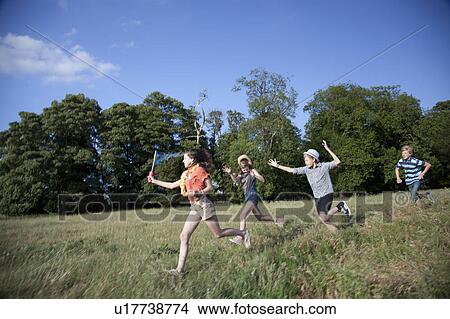 Children playing together in field View Large Photo Image Picture - Children playing together in field. Fotosearch