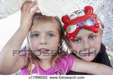 Stock Image - Children playing under blanket. Fotosearch