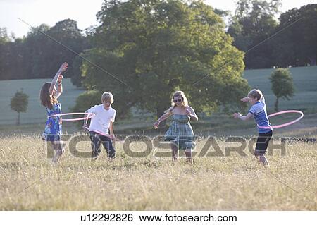 Children playing with hula hoops View Large Photo Image Stock Photograph - Children playing with hula hoops. Fotosearch