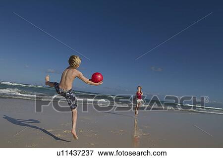 Children playing with red ball on beach View Large Photo Image Stock Photo - Children playing with red ball on beach. Fotosearch