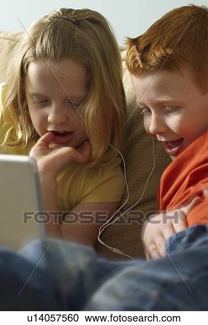 Children sharing headphones and laptop View Large Photo Image Stock Image - Children sharing headphones and laptop. Fotosearch