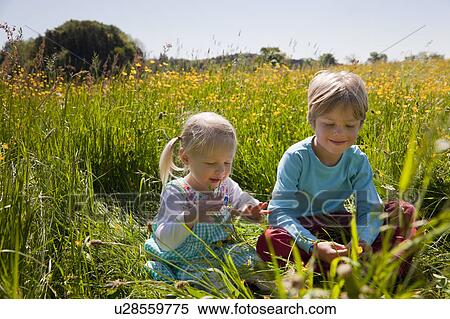 Children sitting in field of flowers View Large Photo Image Stock Photography - Children sitting in field of flowers. Fotosearch